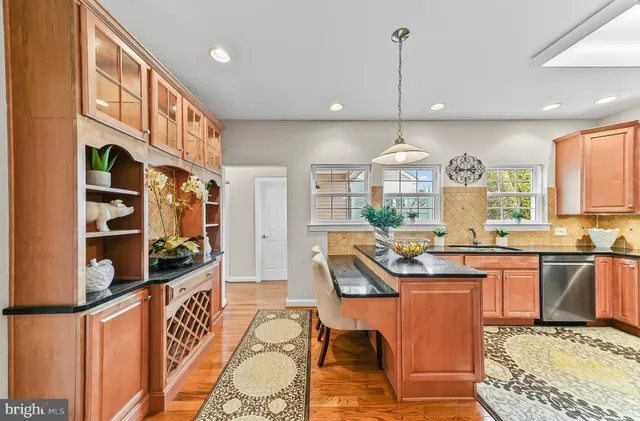 a kitchen with stainless steel appliances granite countertop a sink and cabinets