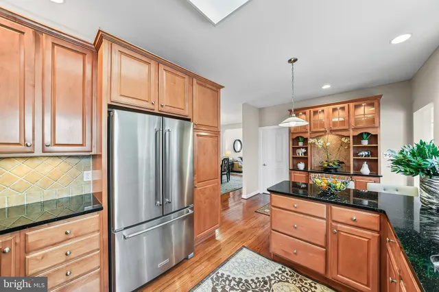 a kitchen with stainless steel appliances granite countertop a refrigerator and a sink