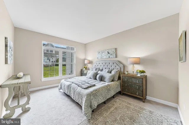 a spacious bedroom with a bed and a window