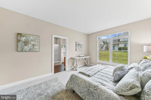 a bedroom with a large bed and a window