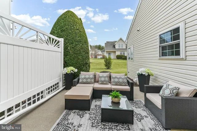a balcony with furniture and a potted plant