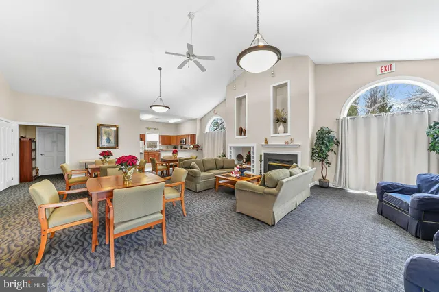 a view of a dining room with furniture and a chandelier