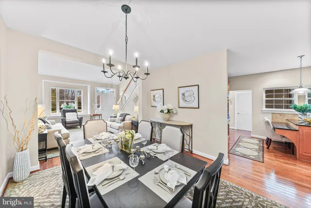 a view of a dining room with furniture wooden floor and chandelier