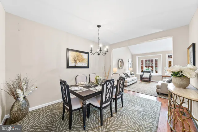 a view of a dining room with furniture and chandelier