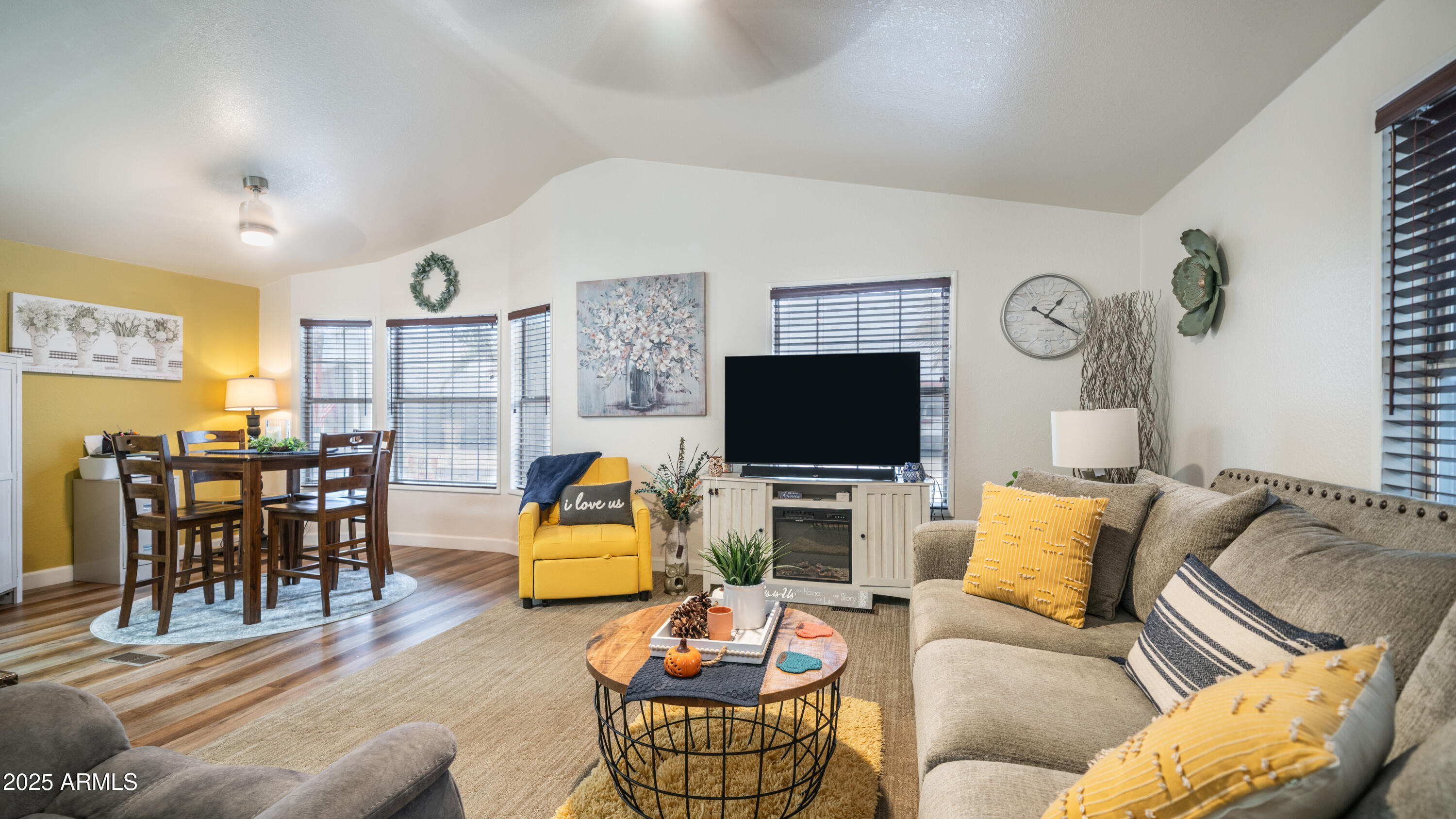 3355 South Cortez Road, Unit 98 Apache Junction, AZ 85119 - Photo 11 of 46 a living room with furniture kitchen view and a flat screen tv