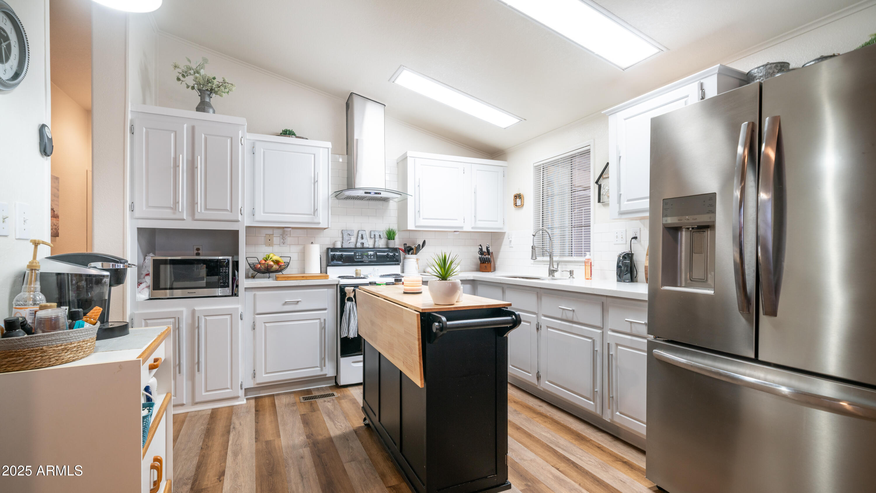 3355 South Cortez Road, Unit 98 Apache Junction, AZ 85119 - Photo 14 of 46 a kitchen with stainless steel appliances granite countertop a refrigerator a oven a sink dishwasher and white cabinets with wooden floor