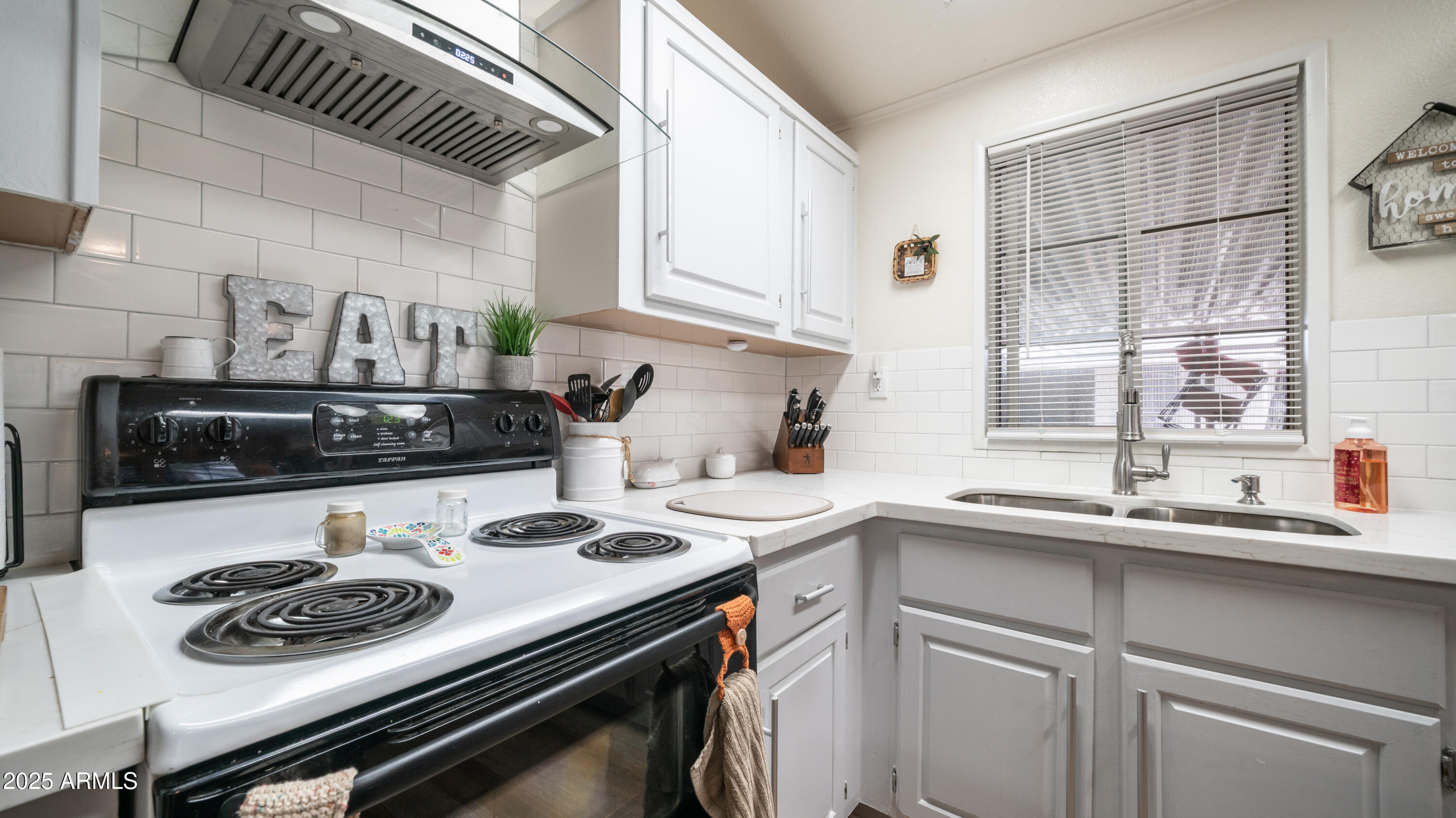 3355 South Cortez Road, Unit 98 Apache Junction, AZ 85119 - Photo 16 of 46 a kitchen with a sink stove and cabinets