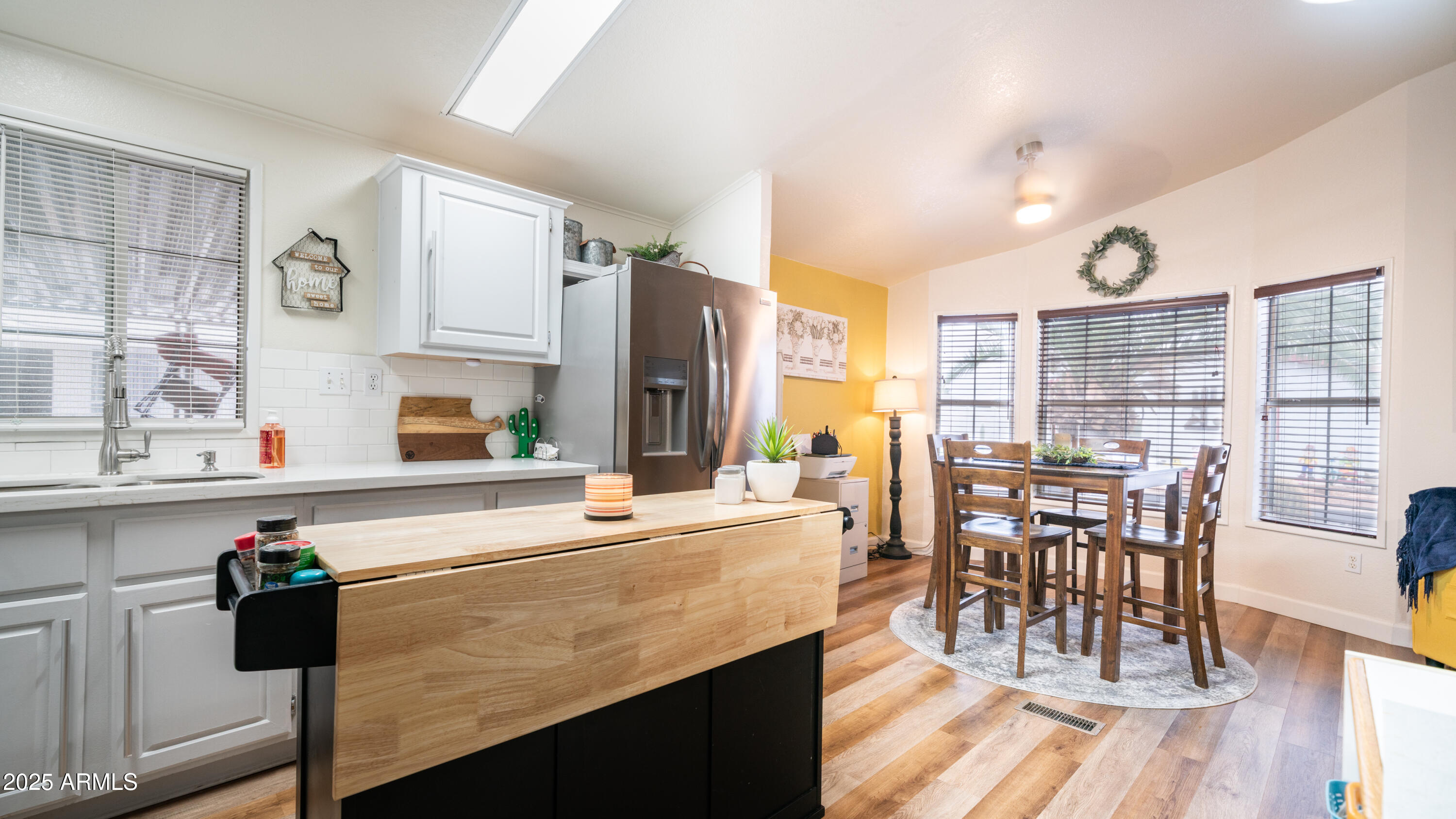 3355 South Cortez Road, Unit 98 Apache Junction, AZ 85119 - Photo 18 of 46 a kitchen with stainless steel appliances granite countertop a table chairs stove and sink