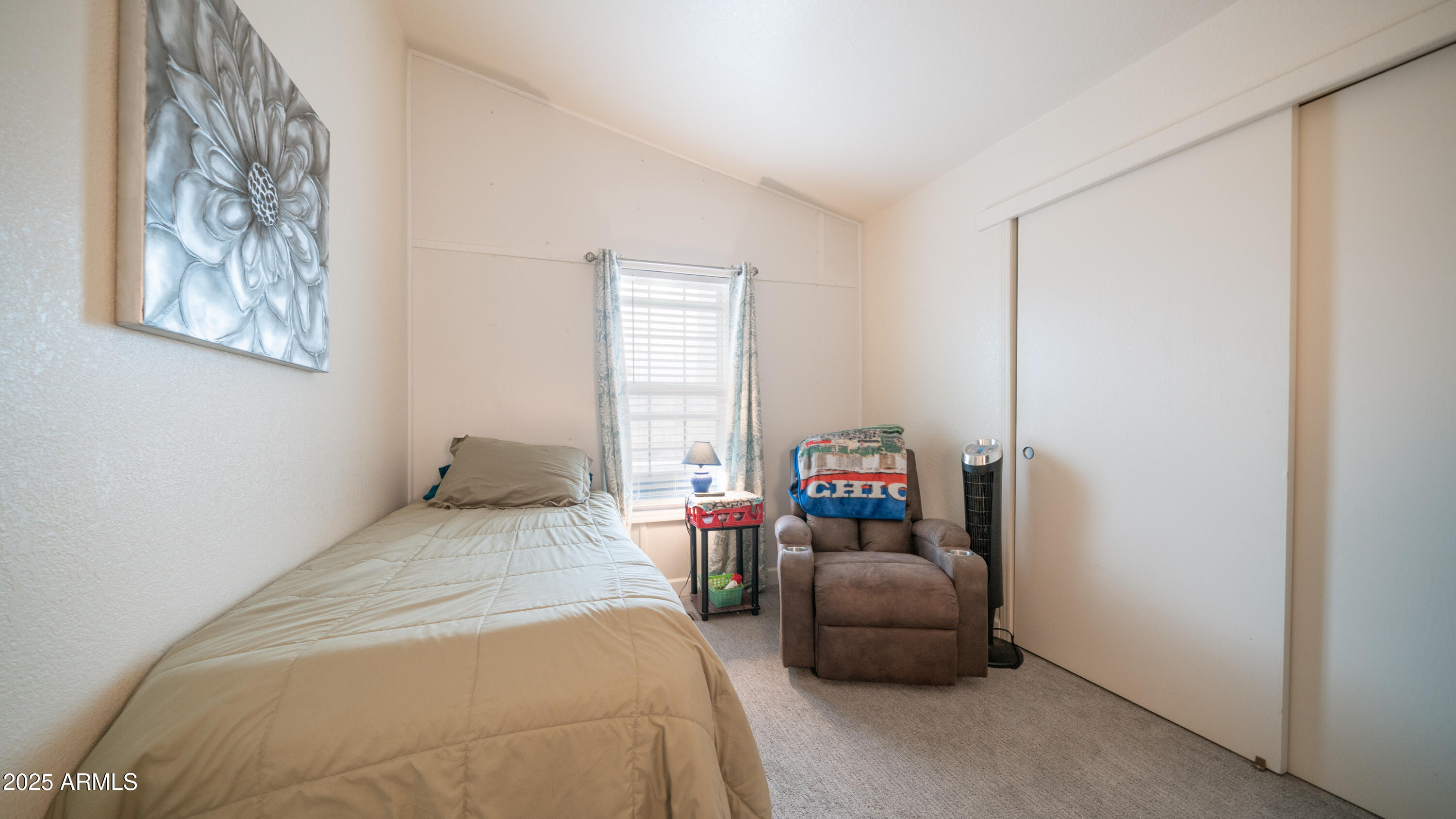 3355 South Cortez Road, Unit 98 Apache Junction, AZ 85119 - Photo 27 of 46 a bedroom with a bed and a couch