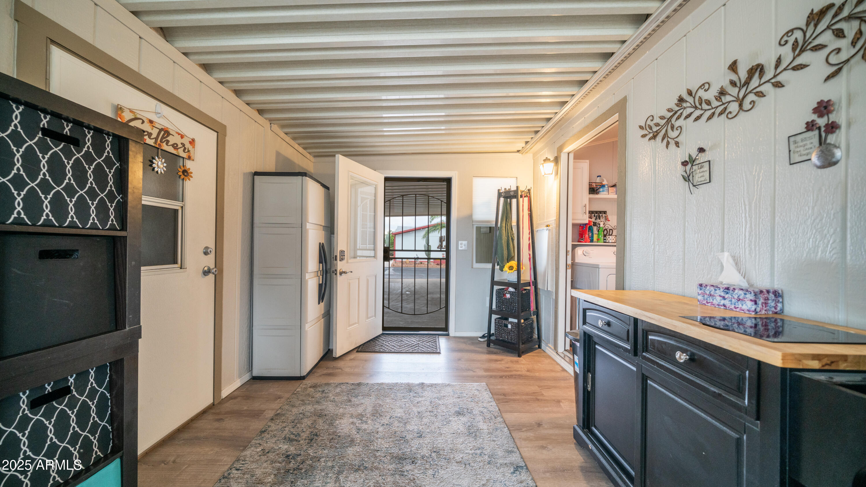 3355 South Cortez Road, Unit 98 Apache Junction, AZ 85119 - Photo 35 of 46 a hallway with cabinets and wooden floor