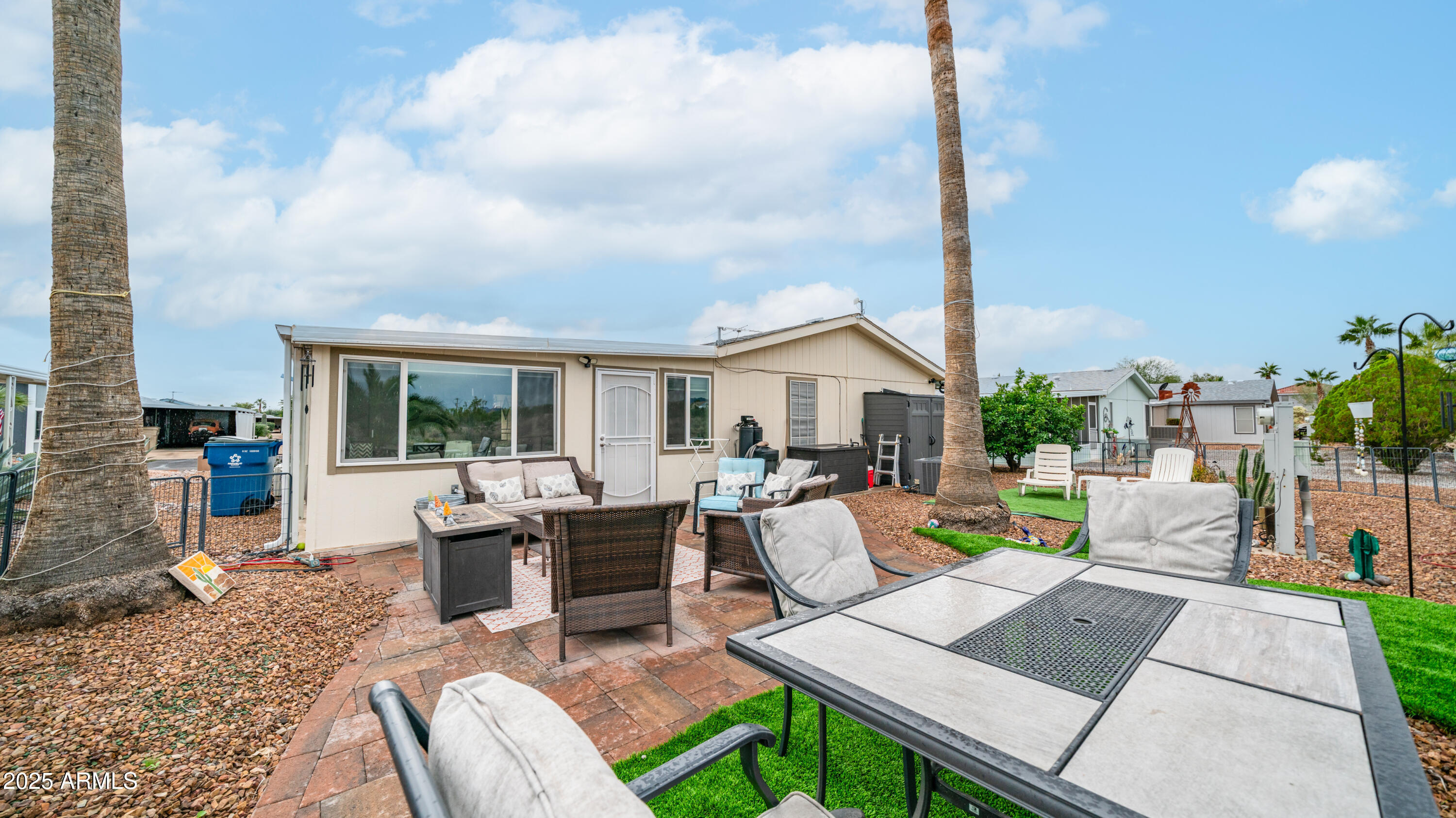 3355 South Cortez Road, Unit 98 Apache Junction, AZ 85119 - Photo 41 of 46 a view of a patio with couches chairs dining table and chairs