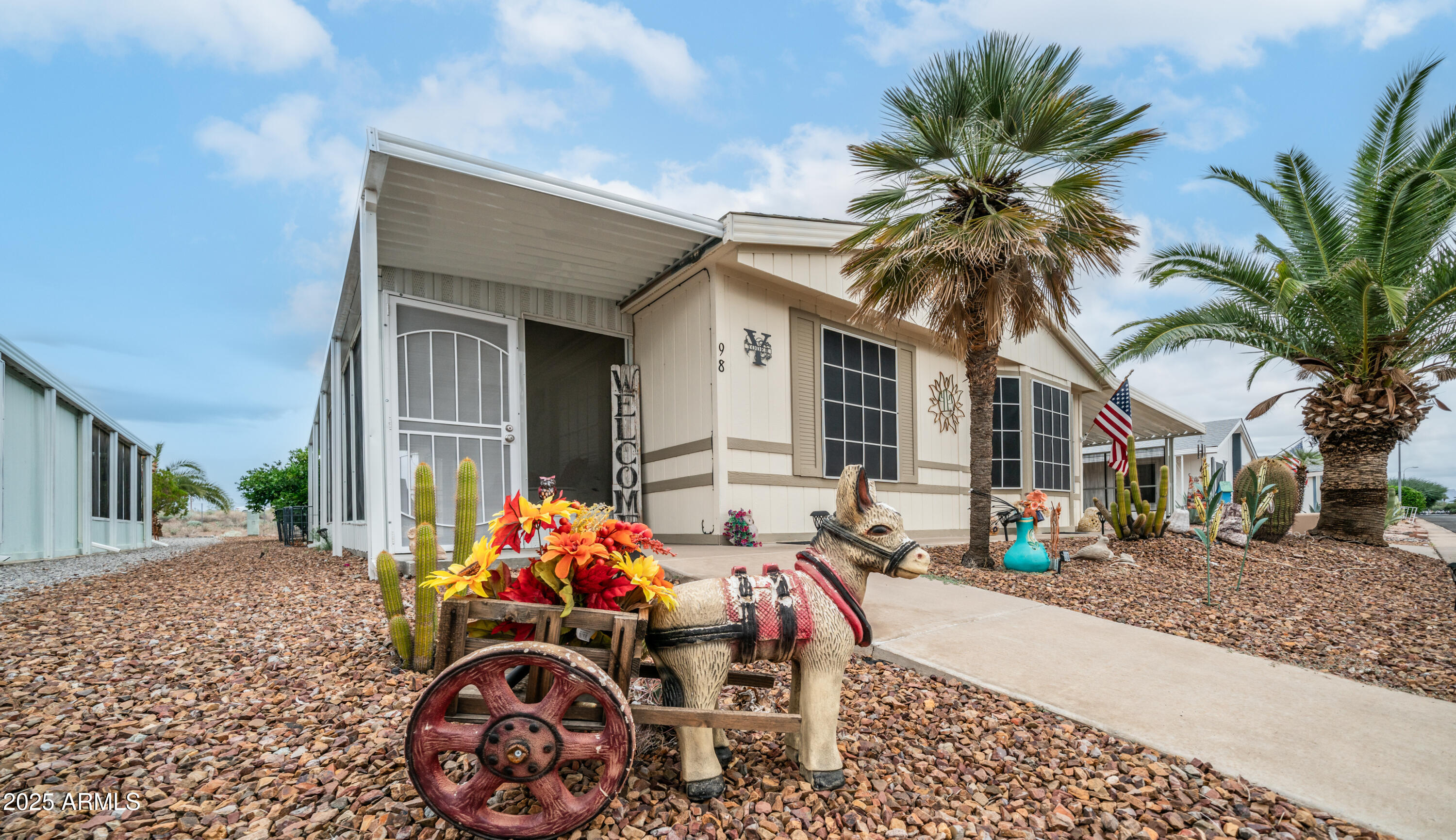 3355 South Cortez Road, Unit 98 Apache Junction, AZ 85119 - Photo 8 of 46 a front view of house with yard outdoor seating