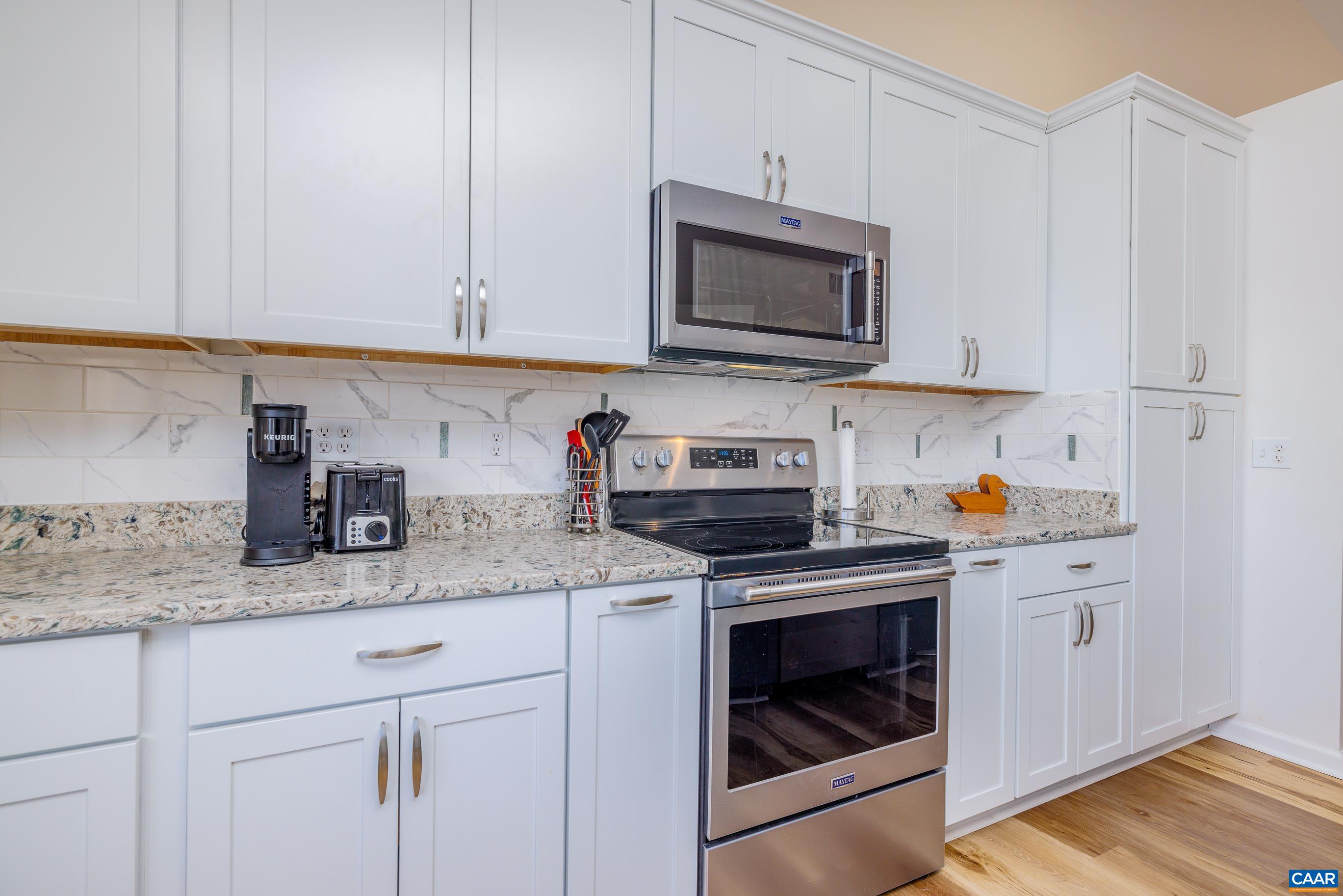 B3 Marina Point Palmyra, VA 22963 - Photo 11 of 47 a kitchen with stainless steel appliances granite countertop white cabinets sink and a granite counter top