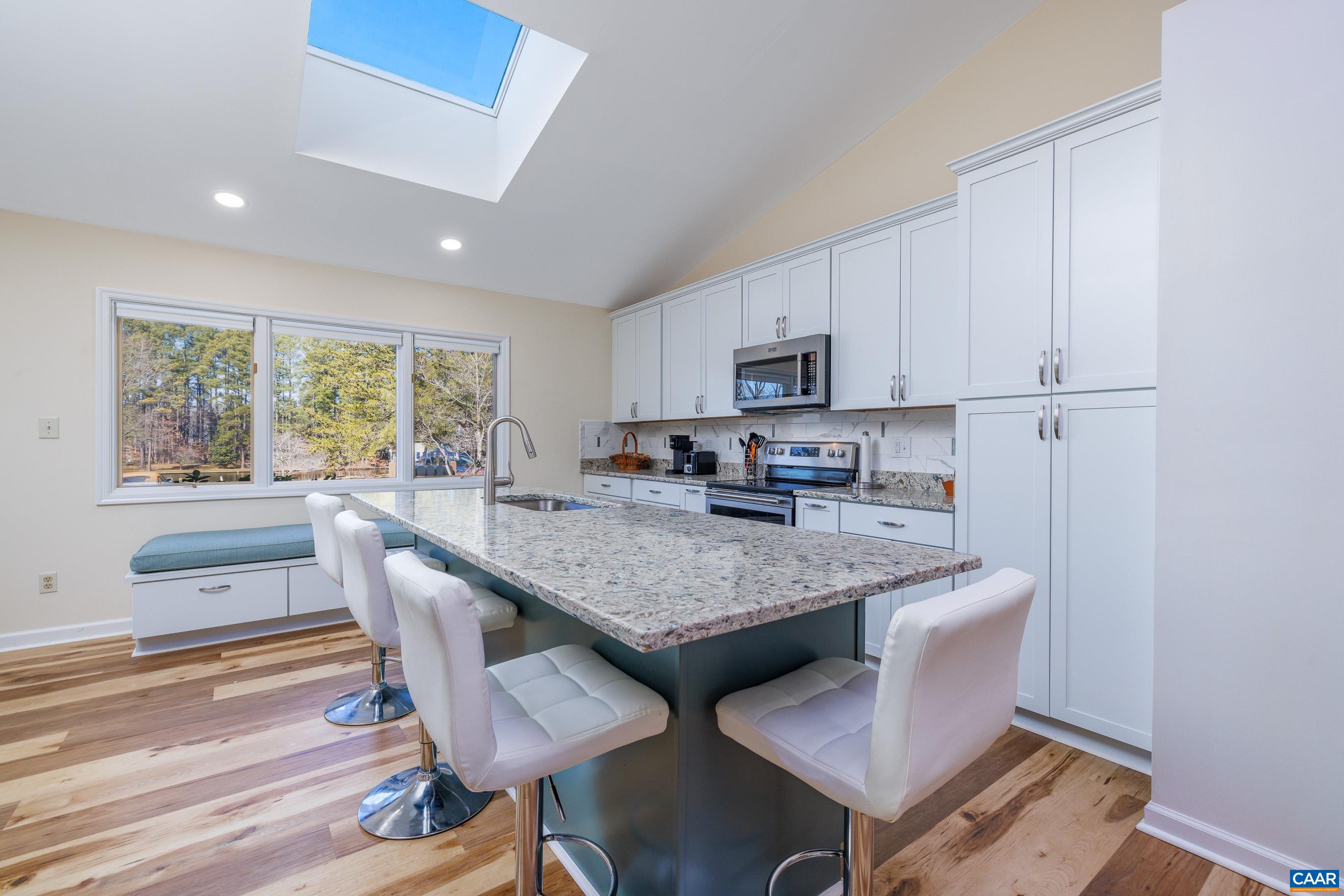 B3 Marina Point Palmyra, VA 22963 - Photo 7 of 47 a kitchen with stainless steel appliances granite countertop a table chairs sink refrigerator and cabinets