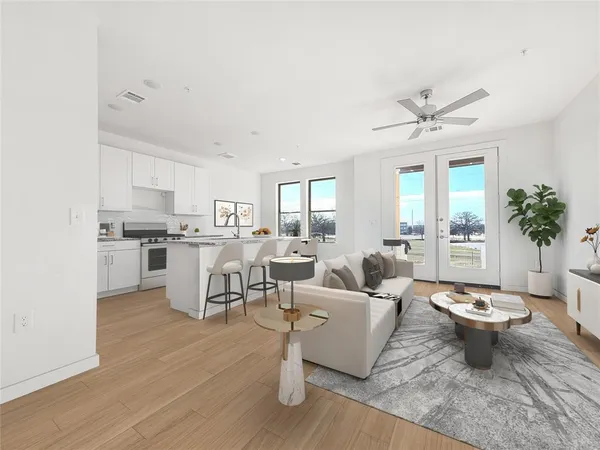 a living room with fireplace furniture and a large window