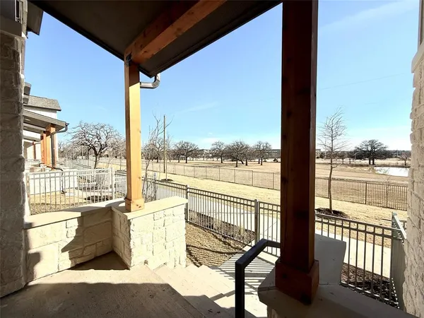 a view of a hallway with wooden cabinets
