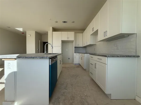 a kitchen with a sink cabinets and window