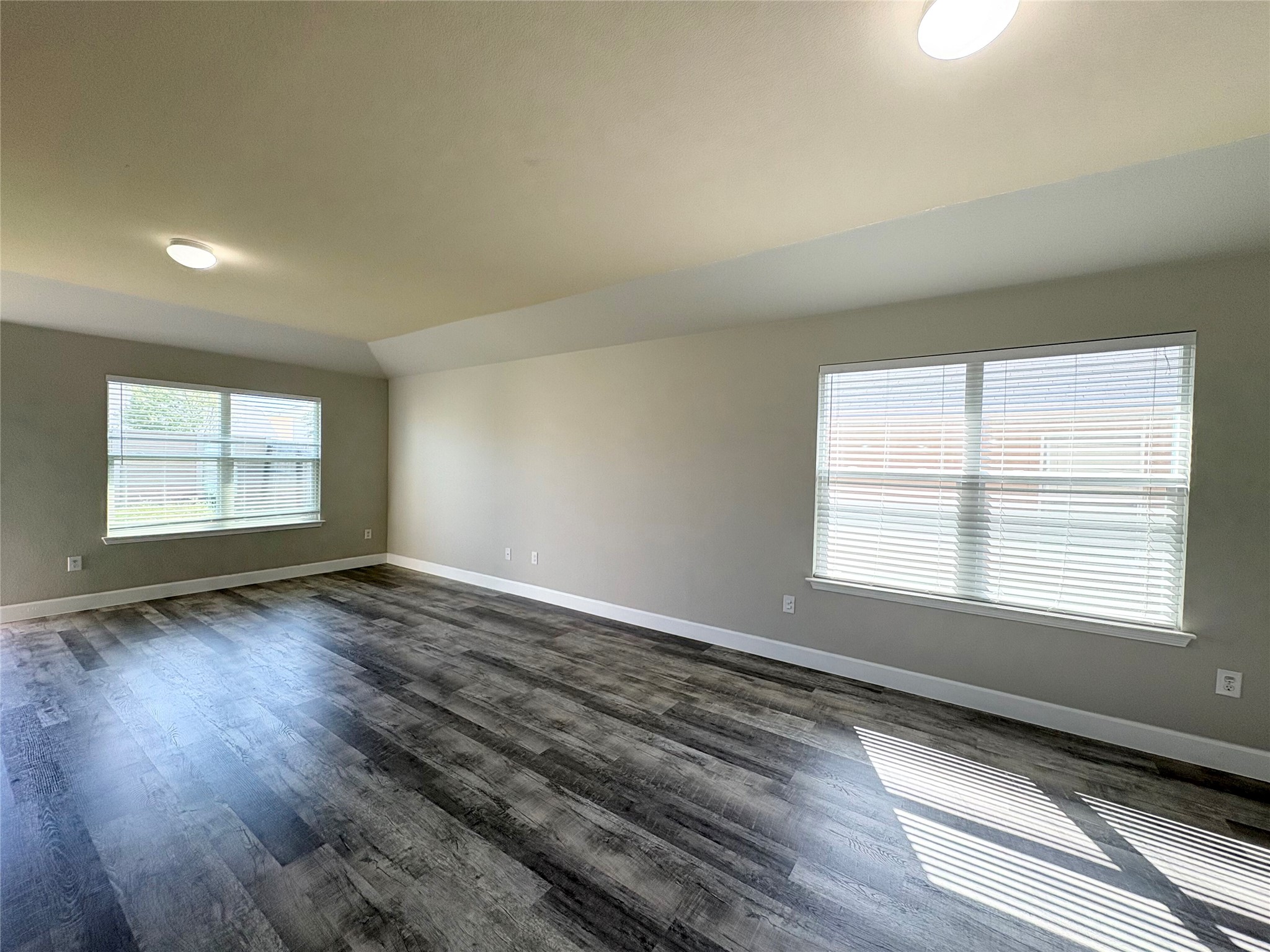 11708 Cambrian Road Manor, TX 78653 - Photo 11 of 31 Natural light filters into this spacious room featuring modern wood-look flooring.