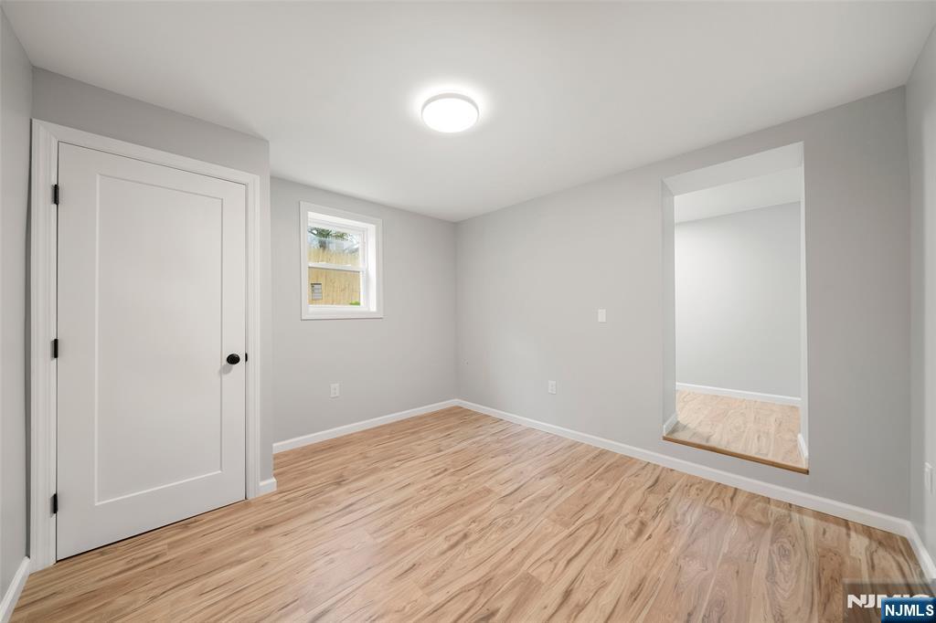 174 Pleasant Avenue Bergenfield, NJ 07621 - Photo 14 of 18 a view of an empty room with wooden floor