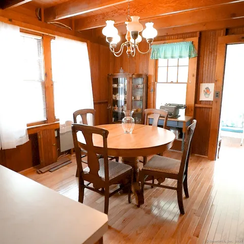 a kitchen with a sink a stove and chairs