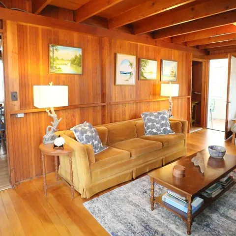 a living room with furniture a fireplace and a table