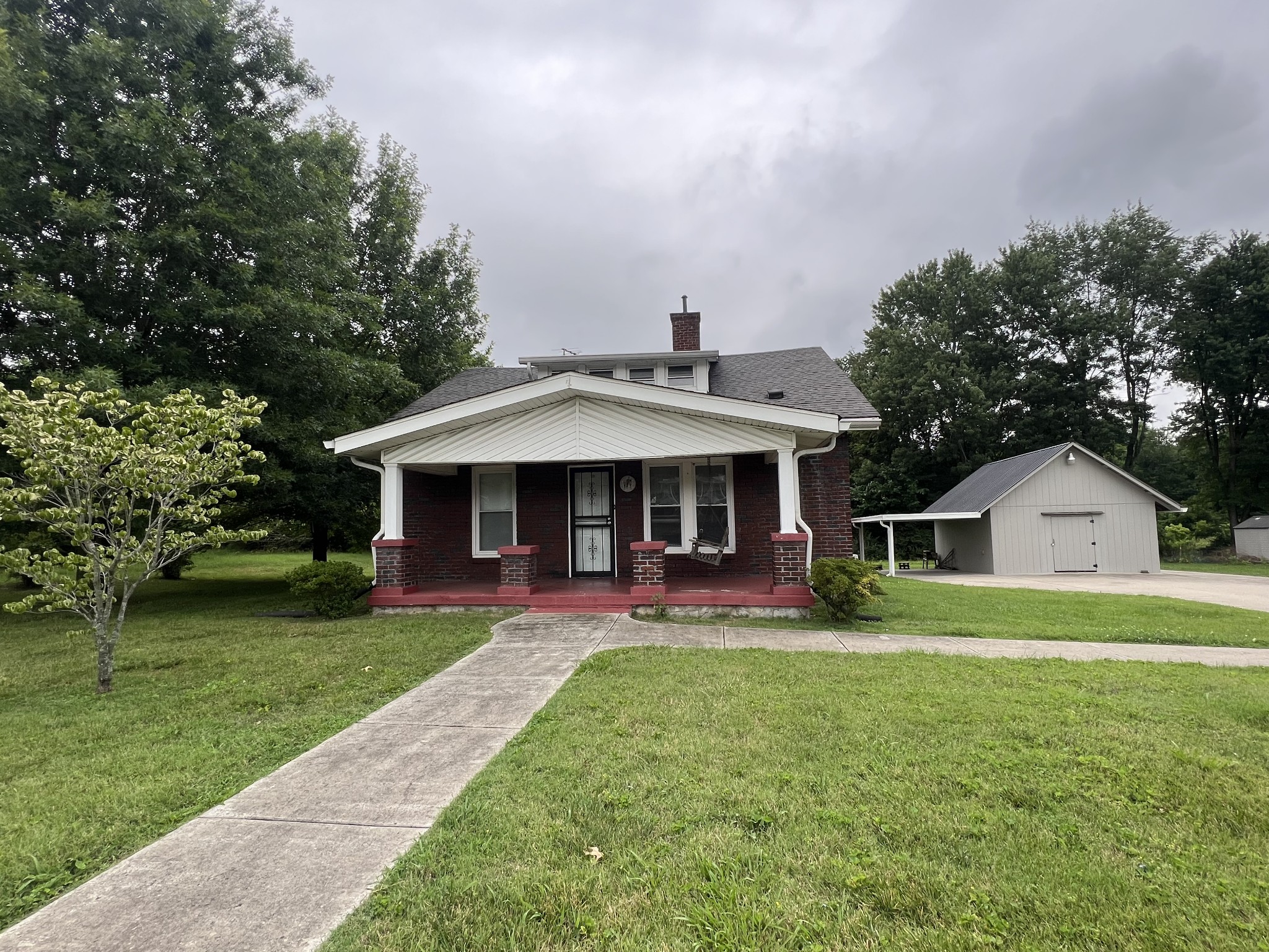 a front view of a house with a yard table and chairs