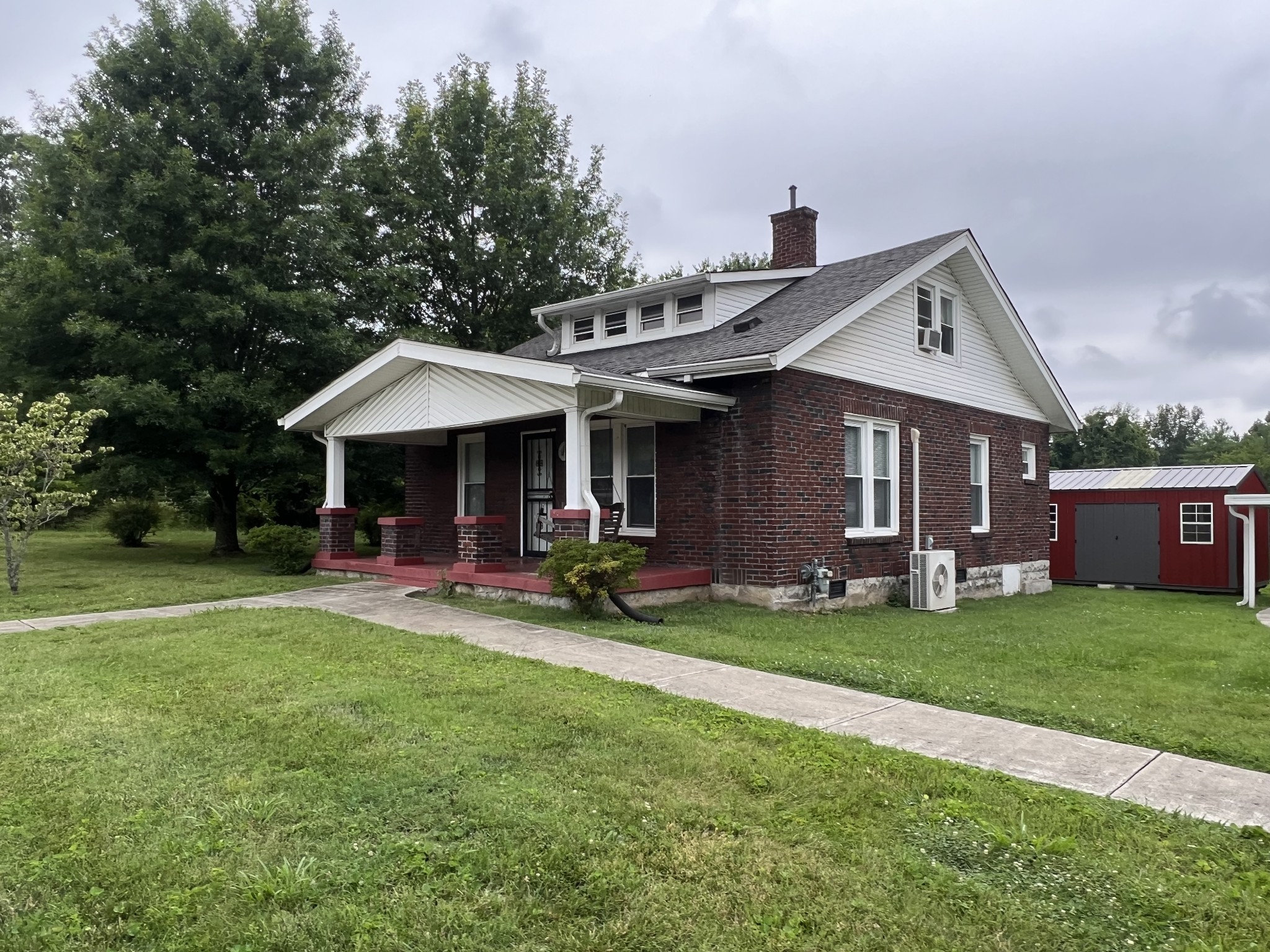 204 Portland Road White House, TN 37188 - Photo 3 of 13 a front view of a house with a garden and trees