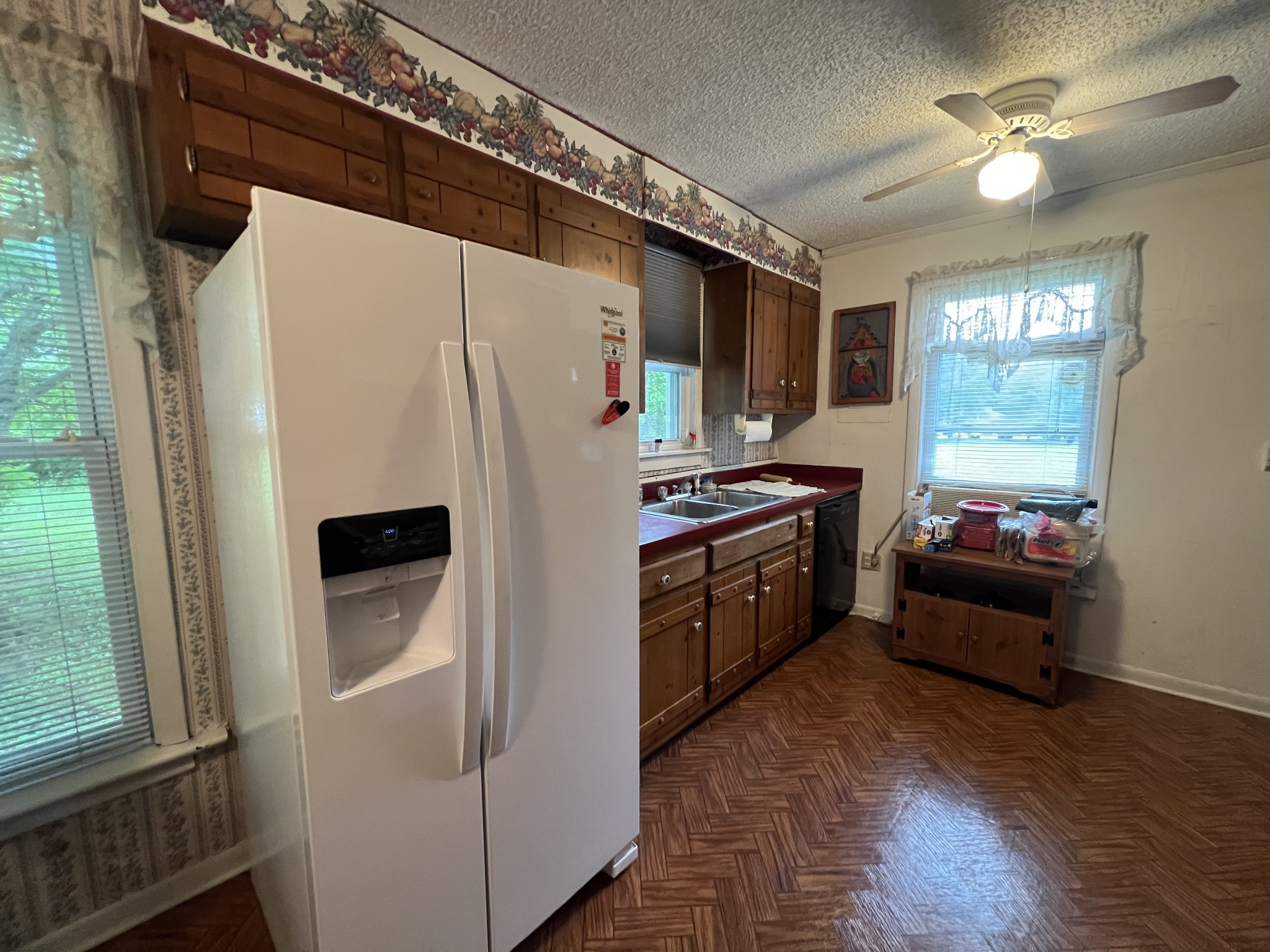 204 Portland Road White House, TN 37188 - Photo 8 of 13 a kitchen with stainless steel appliances a refrigerator a stove a sink and dishwasher with wooden floor