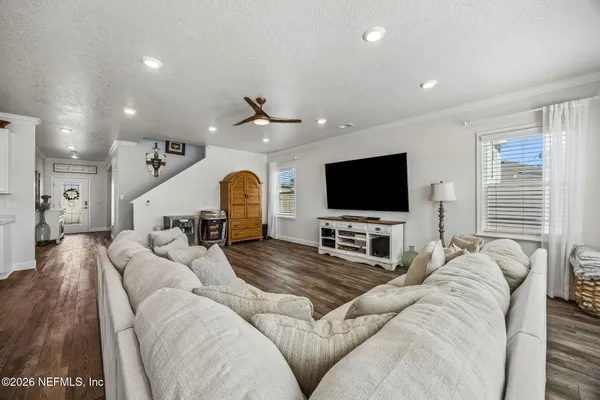 a kitchen with stainless steel appliances granite countertop a sink and a stove with wooden floor