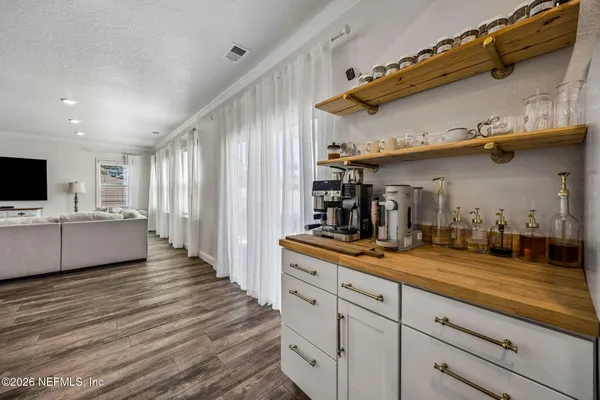 a bedroom with a bed and a flat tv screen on the dresser