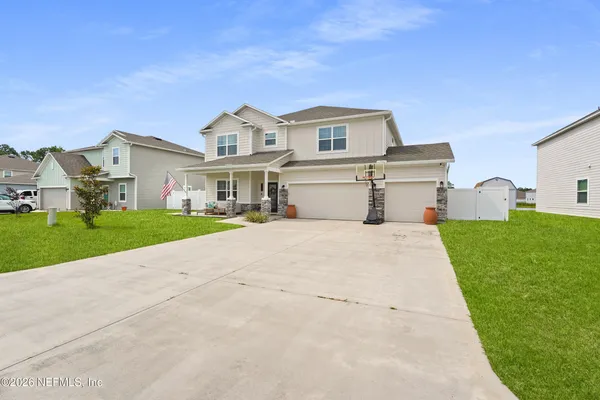 a view of a house with backyard and sitting area