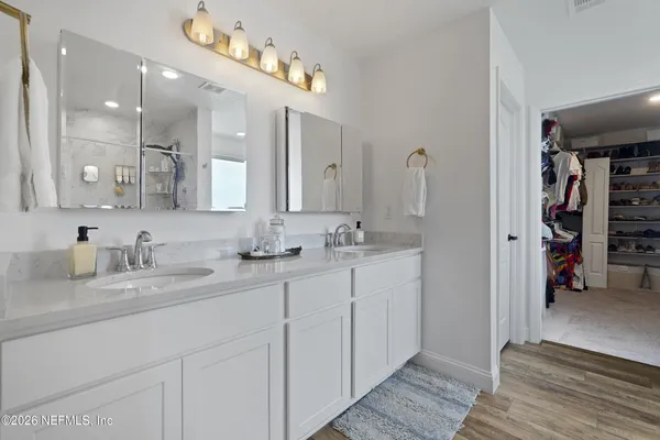 a view of a lake with couches and wooden floor