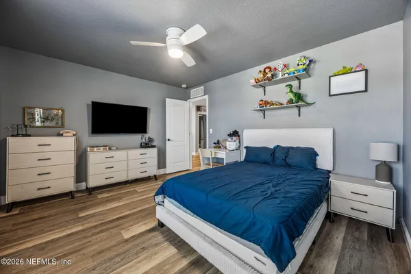 an aerial view of a house with a garden and lake view