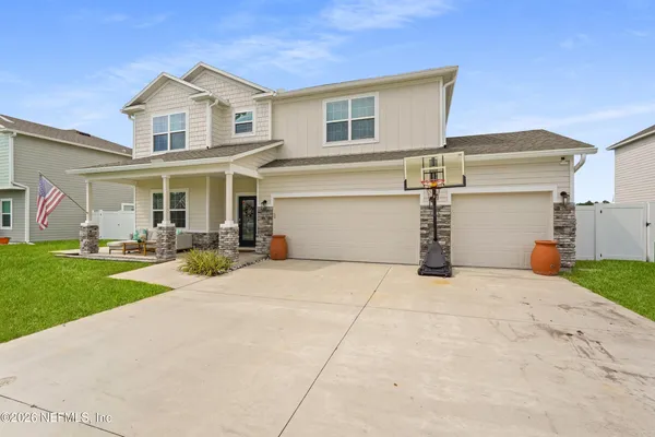 a view of a hallway with furniture and wooden floor