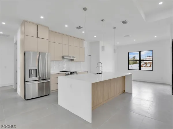 a kitchen with refrigerator and cabinets