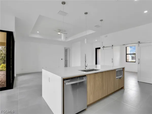 a kitchen with a sink stove and cabinets