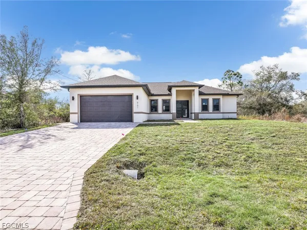 a front view of a house with a yard and garage