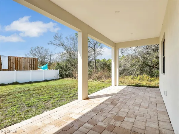 a view of a porch with a floor to ceiling window next to a yard