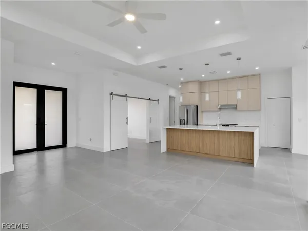 a large kitchen with a large window and a sink