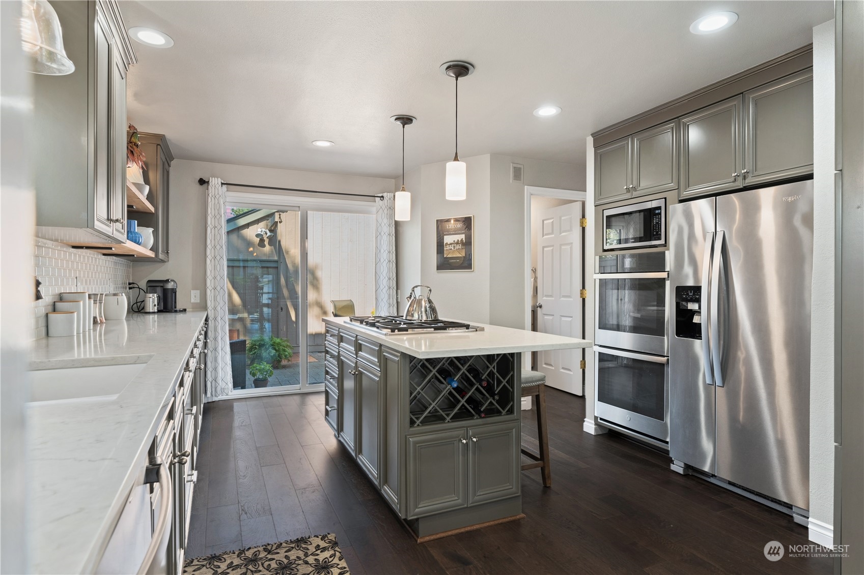 2900 Kennewick Place Northeast Renton, WA 98056 - Photo 12 of 40 a kitchen with kitchen island a counter top space a sink stainless steel appliances and cabinets