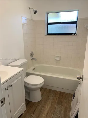 a bathroom with a toilet a sink and bathtub