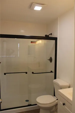 a bathroom with a toilet a sink and a shower