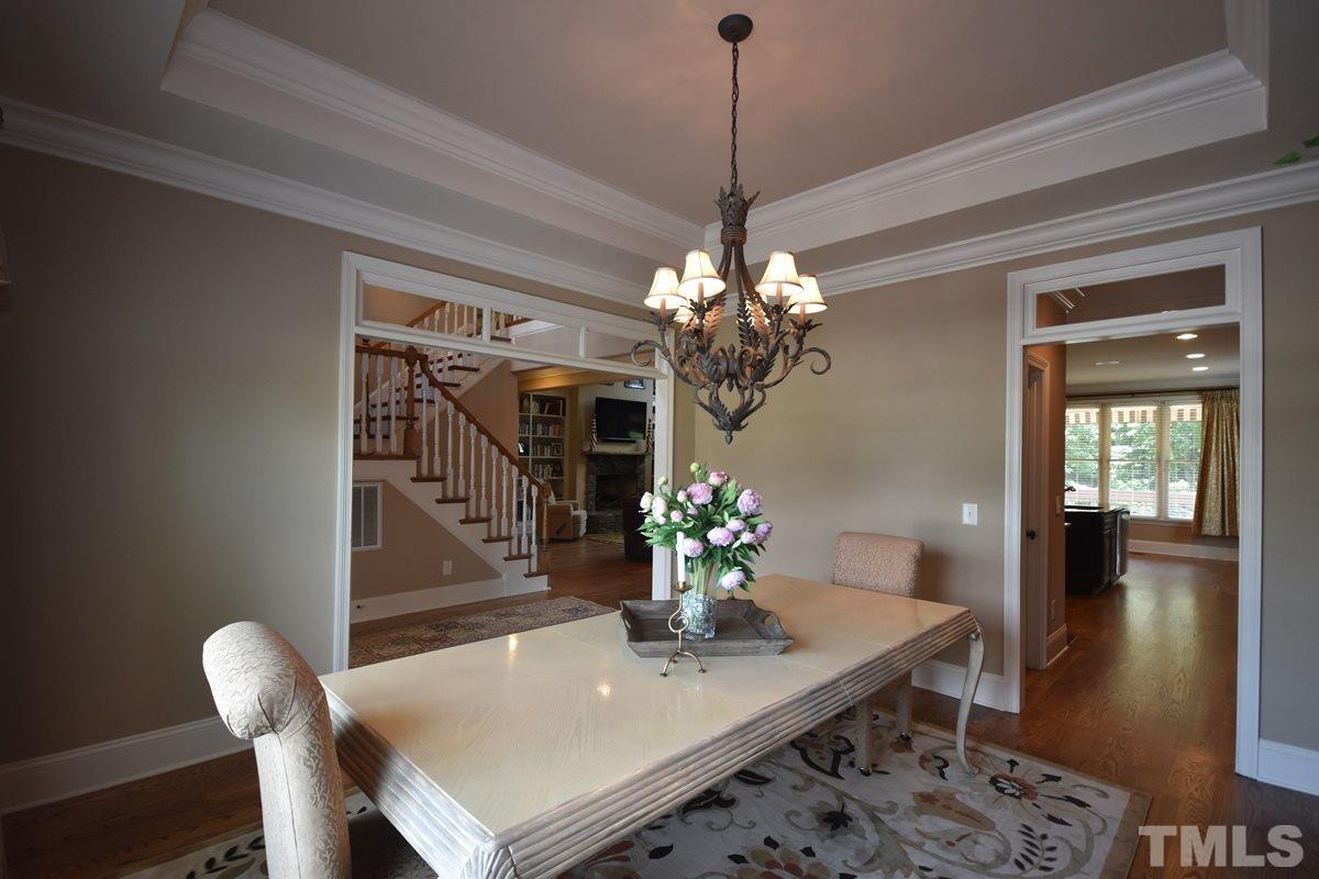 4012 Limerick Road Burlington, NC 27215 - Photo 4 of 24 a view of a dining room with furniture wooden floor and chandelier