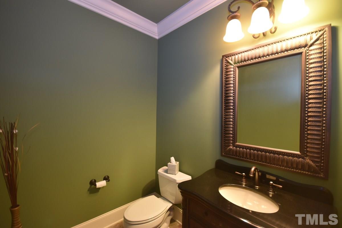 4012 Limerick Road Burlington, NC 27215 - Photo 10 of 24 a bathroom with a toilet sink vanity and mirror
