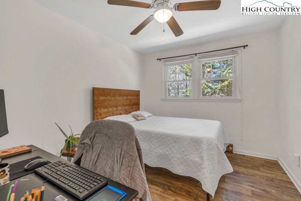 156 Olancha Avenue Boone, NC 28607 - Photo 12 of 23 a bedroom with a bed and wooden floor