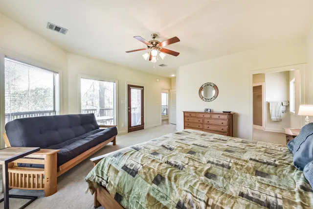 a living room with a bed furniture and a window