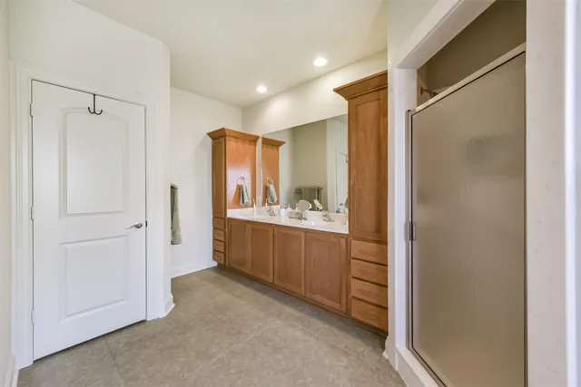 a bathroom with a mirror and a shower