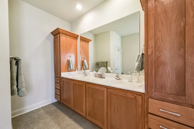 a bathroom with a double vanity sink and mirror