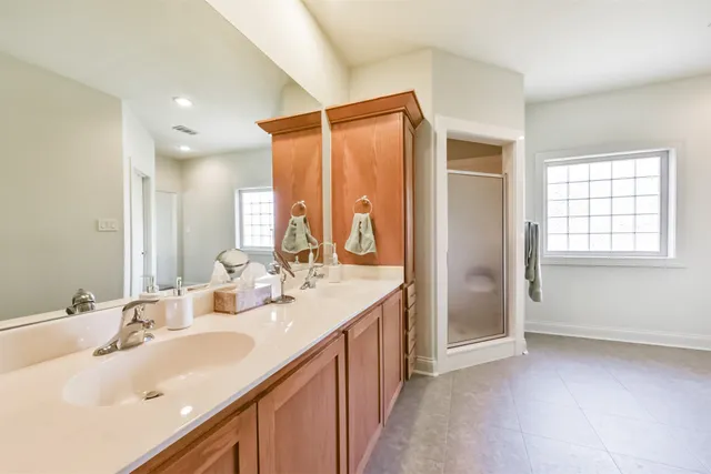 a bathroom with a double vanity sink and a mirror