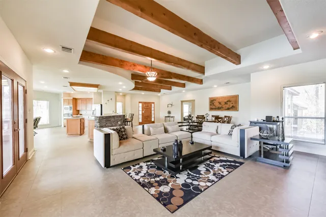 a living room with furniture rug and a large window